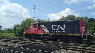 CN EMD GP9RM 7246 & GP38-2 7521 With a yard slug are switching auto parts cars in Oakville CN Yard