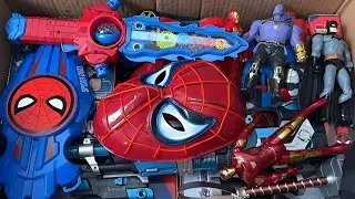 Open box toys, including Spider Man toy gun, shield, Captain America toy, Spider Man mask, Marvel 