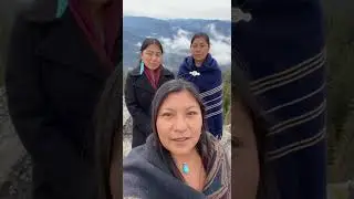 The two women behind her stand evenly spaced, calm and attentive.