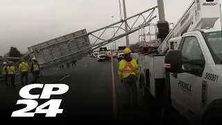 Truck driver charged after overhead sign falls on Highway 401