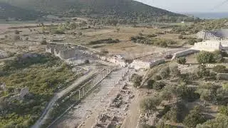D-Log M. Gelemis, Turkey. Colonnaded Street ruins with stone columns and Agora remains in Patara ...