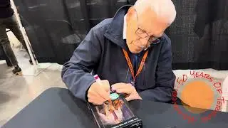 Tom Atkins of Halloween III: Season of the Witch signs autographs.