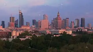 Aerial view of Warsaw city center with its modern skyscrapers changing colors during sunset with