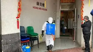 Hong Kong housing block evacuated after double virus find | AFP