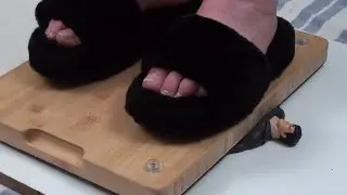 SUPERMAN CRUSHED UNDER A WOODEN BOARD WITH MY BLACK SLIPPERS