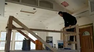 Homemade wooden scaffolding on wheels for sheetrock
