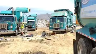 Garbage Truck Driver POV: Operating a Sideloader Garbage Truck. Dumping. Landfill. Can collection