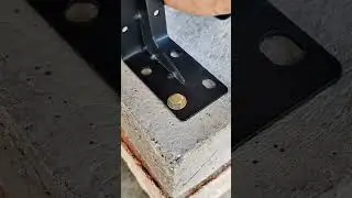 Installing anchor bolt into concrete base plate using hammer for secure structural metal joint