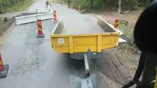 Wheel excavator with trailer working at road