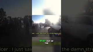 Intense Confrontation: Officer Battles Rowdy Crowd on the Street
