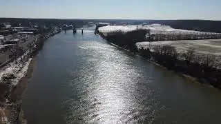 Aerial Drone Footage Cumberland River in Clarksville, TN over river and snowy field 4K Stock