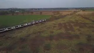 Train passing over Thorrington Level Crossing in the evening.