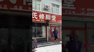 As the storefront sign caught fire,  a passerby put out the flames with just a handful of snow.