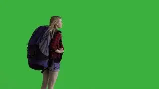 young attractive female hiker with a backpack looking into the distance green screen prores 422hq 4k