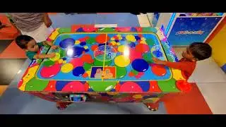 Kids Playing Air hockey table game......