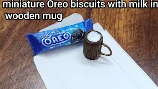 Miniature Oreo biscuits making with milk in wooden mug paper art 