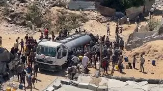 Gaza City residents wait at truck for water after famine declared