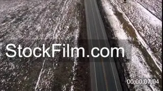 Aerial drone fly over empty lonely winter paved road that splits to 2 directions. COLORADO