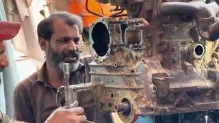 An expert mechanic repairs a rusty tractor that has been left in the rain for years