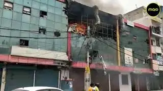 Building on fire in Delhi's Azadpur market, firemen are engaged in controlling the fire.
