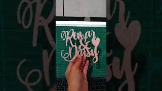 Cutting customized cake topper in glittered rose gold
