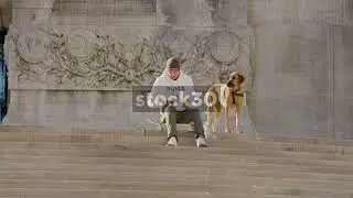Man Sitting On Skateboard With Dog At Soldiers & Sailors Monument, Indianapolis, USA