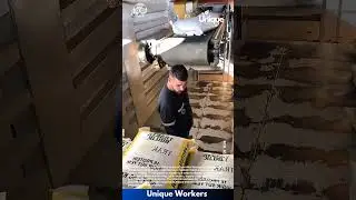 Moving feed bags with a machine: people moving feed bags with a machine