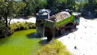 Dump truck unload soil for delete the pond