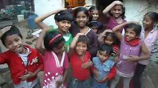 Children at the Baljeet Nagar slum school patting their heads and rubbing their tummies