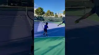 7 year old playing a tennis pro