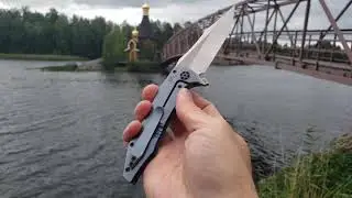 Нож CKF/GAVKO Tiger Flipper M390, титан на фоне Островной Церкви в ЛО