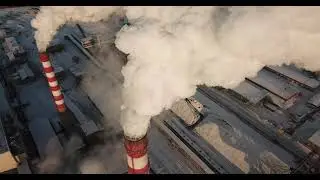 a huge amount of smoke comes out of the Industrial chimney in winter