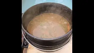 Beef Stew In Cast Iron Cauldron In Hot Coals.