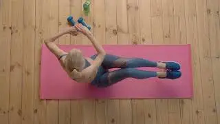 Overhead view of motivated sporty fit senior woman practicing trunk seated rotation exercise in v up