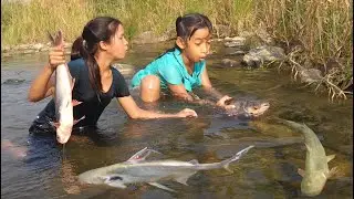 Two sister catch fish by hand for food- Grilled fish for dinner cook and eat tasty delicious