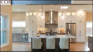 A Kitchen, Stairs, and Family room remodel with a bearing wall removed! Design through construction