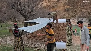 Leila and Shahin are happily installing the roof plate of the mountain hut.