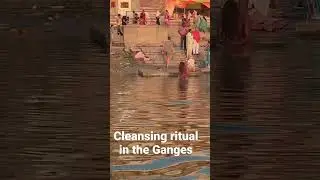 Man cleansing in the Ganges River in Varanasi, India.