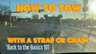 How to tow a vehicle with a strap or chain.