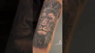 Lion with Crown Tattoo | Black & Grey Design with Red Jewel Accents