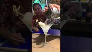 Bee pouring me a Lychee Martini at Margarita Beach, Khanom, Thailand