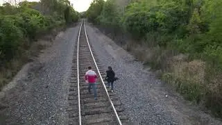 Free Video of people running on Train Tracks / Railway | 4K | Royalty Free Video | Drone view