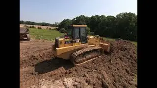 Caterpillar 973C pushing topsoil