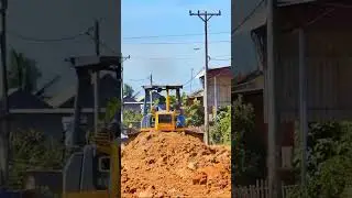 Seeing the wonder of a bulldozer pushing the ground smoothly.