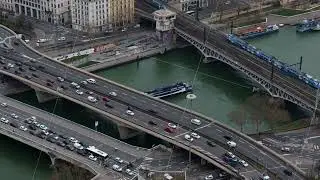 Urban Lyon bridge crossing, aerial view revealing motorized traffic and train over Saone River