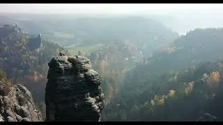 Breathtaking landscape,forest canopy with soft sunlight filtering, a cascading waterfall.