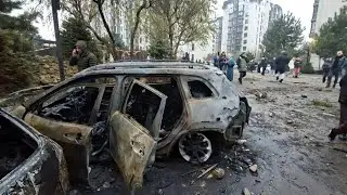 Damaged residential building, torched cars after drone strikes in Ukrainian capital | AFP