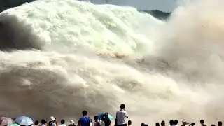 Massive water outflow from dam opening