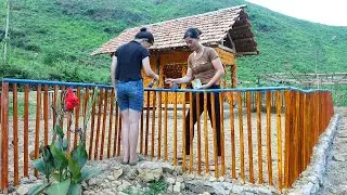Mother and daughter take care of the farm, fence with wooden slats, pick wild fruit