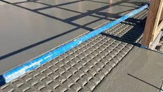 Using the Roll-a-Groove concrete tool to make a less slippery concrete floor for the cows.